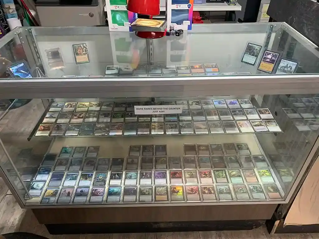 A glass display case full of trading card singles