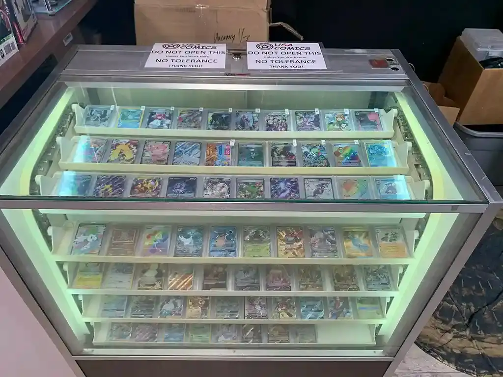 A lit glass case of trading cards