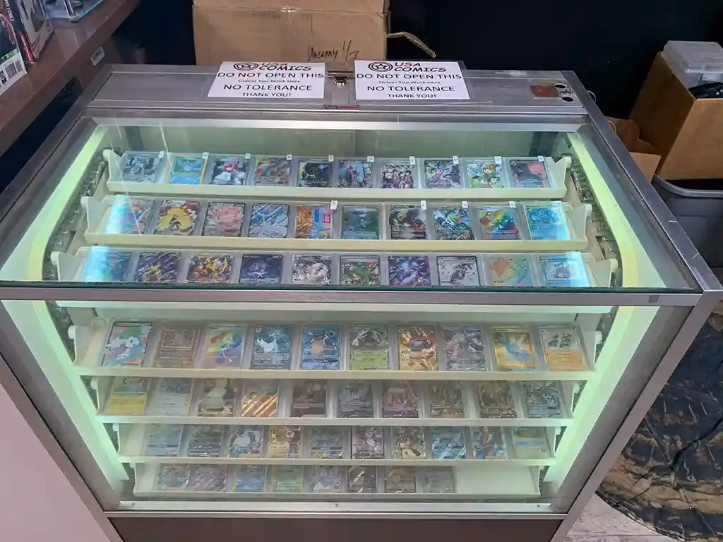 A lit glass case of trading cards