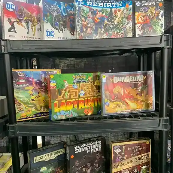 DC Comics and fantasy board games on a shelf