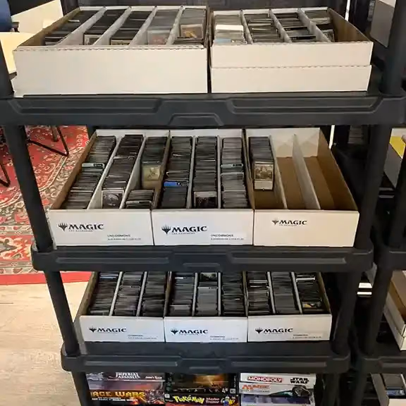 Magic: The Gathering card boxes stacked on shelves