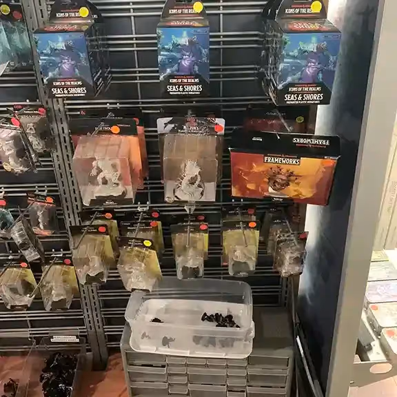 A pegboard wall of packaged miniatures