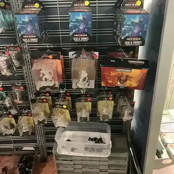 A pegboard wall of packaged miniatures