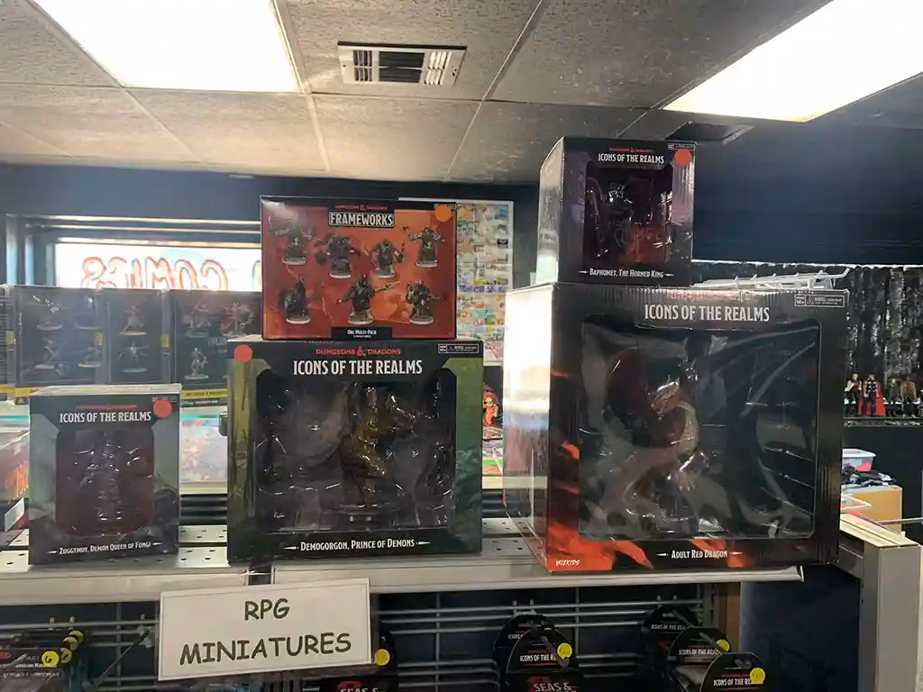 Boxed RPG miniatures on a table with a sign that reads RPG Miniatures