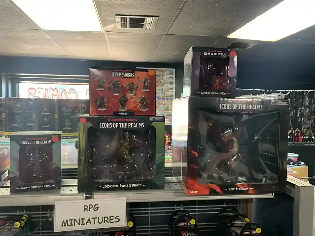 Boxed RPG miniatures on a table with a sign that reads RPG Miniatures